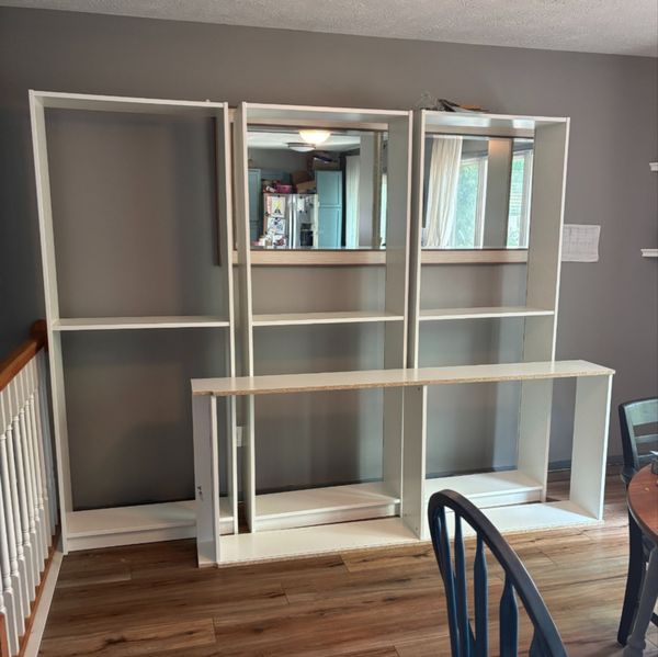 4 white IKEA Billy Bookcases - 3 standing up and one laying on its side